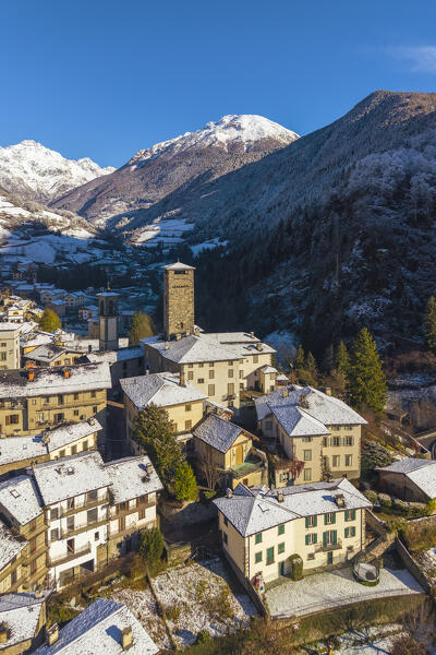The village of Gromo with Pizzo Redorta after a snowfall in winter. Gromo, Val Seriana, Bergamo province, Lombardy, Italy, Europe.