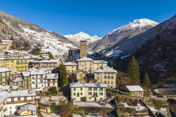 The village of Gromo with Pizzo Redorta after a snowfall in winter. Gromo, Val Seriana, Bergamo province, Lombardy, Italy, Europe.