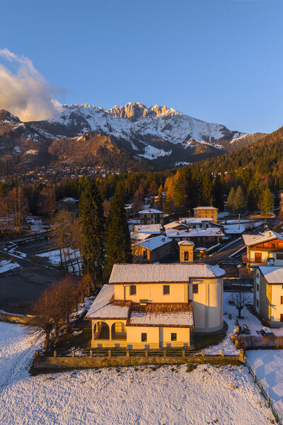 Aerial view of the Santuario di Lantana church and the Presolana covered in snow. Castione della Presolana, Seriana Valley, Bergamo province, Lombardy, Italy.