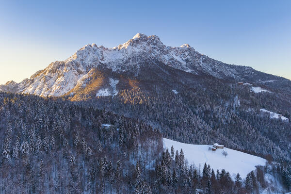 Aerial view of Zambla at sunrise after a snowfall in winter. Val Serina, Zambla Alta, Bergamo district, Lombardy, Italy, Southern Europe.