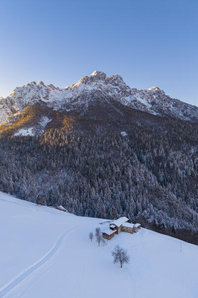 Aerial view of Zambla at sunrise after a snowfall in winter. Val Serina, Zambla Alta, Bergamo district, Lombardy, Italy, Southern Europe.