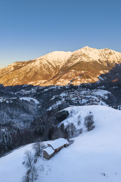 Aerial view of Zambla at sunrise after a snowfall in winter. Val Serina, Zambla Alta, Bergamo district, Lombardy, Italy, Southern Europe.