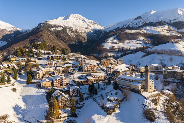 Aerial view of Zambla at sunrise after a snowfall in winter. Val Serina, Zambla Alta, Bergamo district, Lombardy, Italy, Southern Europe.