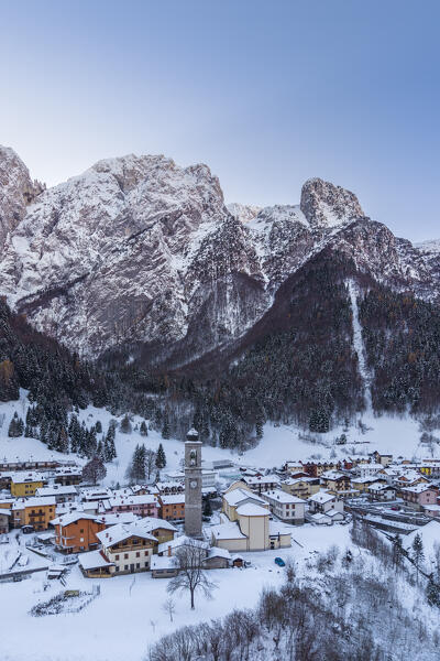 Aerial view of the small church called Cesulì in Colere town with view of the north face of the Presolana mountain in winter after a snowfall. Colere, Val di Scalve, Bergamo district, Lombardy, Italy, Southern Europe.
