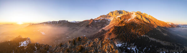 Aerial panorama of the Presolana mountain from Colle Presolana ins winter at sunset. Val Seriana, Castione della Presolana, Bergamo district, Lombardy, Italy, Southern Europe.