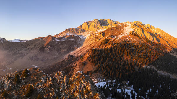 Aerial panorama of the Presolana mountain from Colle Presolana ins winter at sunset. Val Seriana, Castione della Presolana, Bergamo district, Lombardy, Italy, Southern Europe.