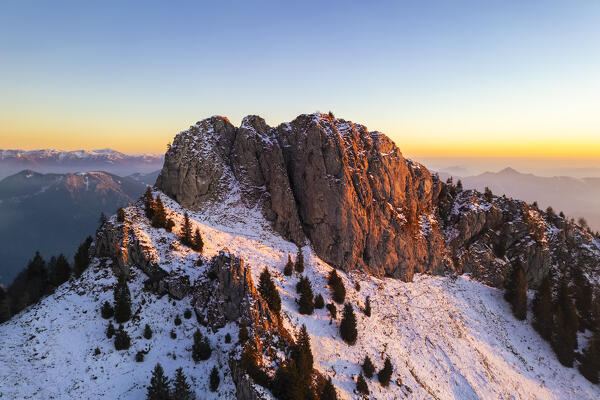 Aerial panorama of the Presolana mountain from Colle Presolana ins winter at sunset. Val Seriana, Castione della Presolana, Bergamo district, Lombardy, Italy, Southern Europe.