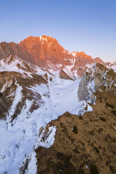 Aerial view of Rino Olmo refuge and Passo Olone with Pizzo della Presolana during a winter sunset. Castione della Presolana, Bergamo province, upper Val Seriana, Lombardy, Italy.
