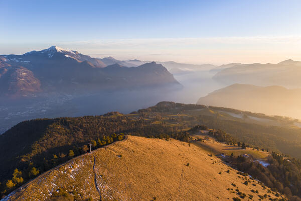 Aerial view of a winter sunset from the top of Monte Colombina looking towards Lake Iseo. Bossico, Lombardy district, Bergamo province, Italy, Europe.