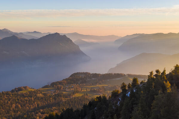 Aerial view of a winter sunset from the top of Monte Colombina looking towards Lake Iseo. Bossico, Lombardy district, Bergamo province, Italy, Europe.