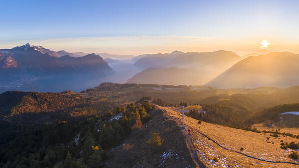 Aerial view of a winter sunset from the top of Monte Colombina looking towards Lake Iseo. Bossico, Lombardy district, Bergamo province, Italy, Europe.