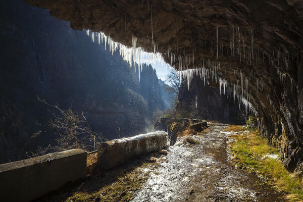 The old Via Mala di Scalve road in winter. Dezzo di Scalve, Val di Scalve, Bergamo province, Lombardy, Italy.