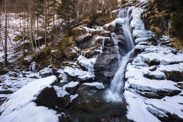 View of the Sèrsen waterfall in winter. Valle Sanguigno, Valgoglio, Val Seriana, Bergamo district, Lombardy, Italy, Southern Europe.
