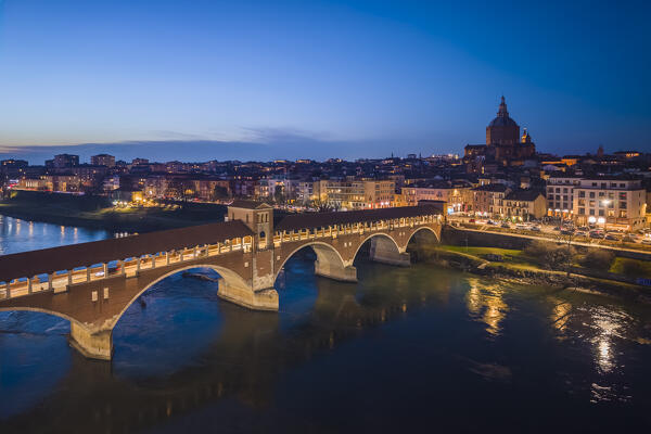 View of the Pavia Covered Bridge in winter at blue hour. Pavia, Lombardy, Italy, Europe.