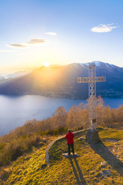 Aerial view of a sunset on Lake Como at the church of San Girolamo located in Alpe Camaggiore. Vendrogno, Bellano, Lecco province, Lombardy, Italy, Europe.