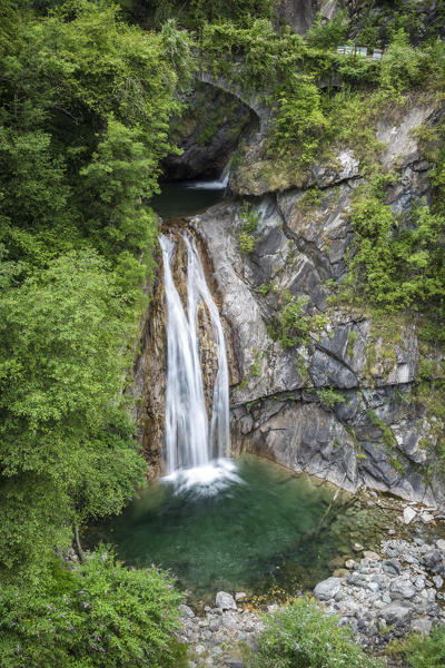 Waterfall under and old bridge of the abandoned road to Bognanco, Val Bognanco, Piedmont, Italy.