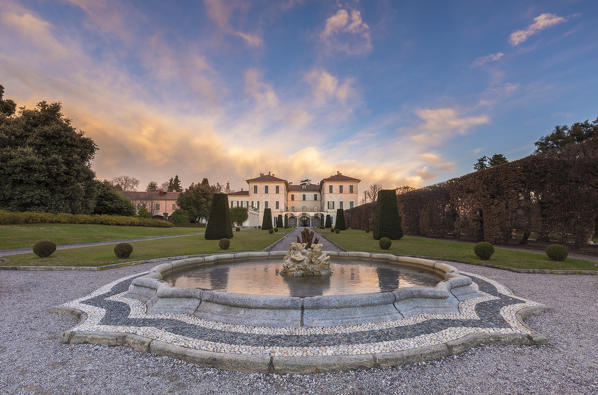 Reflections on the iced fountain of Villa Panza gardens, Varese, Lombardy, Italy.