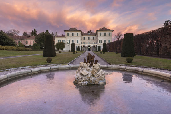 Reflections on the iced fountain of Villa Panza gardens, Varese, Lombardy, Italy.