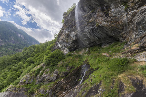 Catwalk under the Sajont waterfall on the trail around Lago di Antrona, Valle Antrona, Piedmont, Italy.