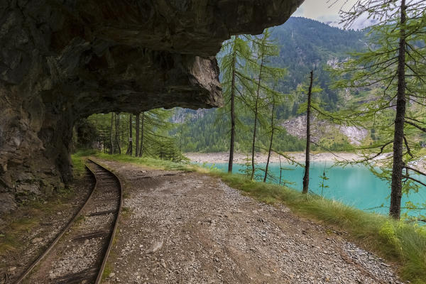 Trail with rails around Lago Campliccioli, Valle Antrona, Piedmont, Italy.