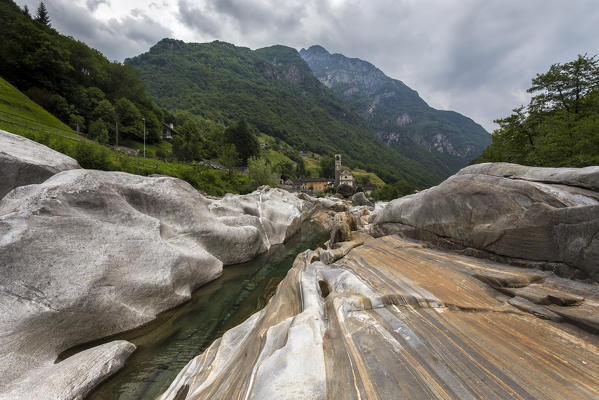 The rocks on the bed of river Verzasca and the church of Lavertezzo, Valle Verzasca, Canton Ticino, Switzerland.