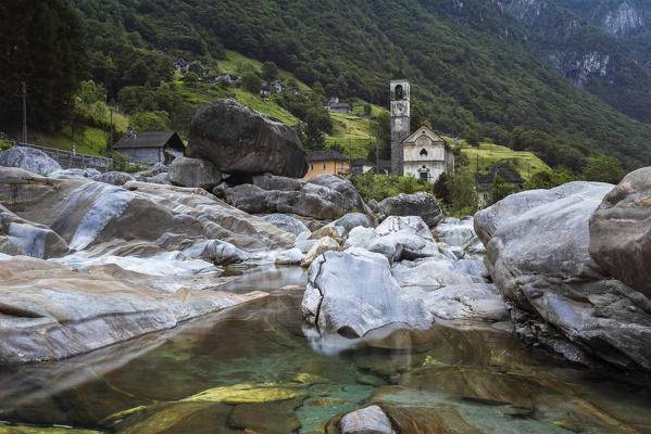 The rocks on the bed of river Verzasca and the church of Lavertezzo, Valle Verzasca, Canton Ticino, Switzerland.