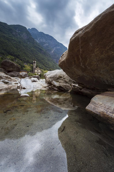 The rocks on the bed of river Verzasca and the church of Lavertezzo, Valle Verzasca, Canton Ticino, Switzerland.