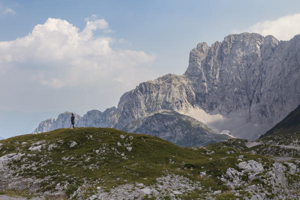 A lonely man staring at the north face of the Presolana, Schilpario, Val di Scalve, Bergamo district, Lombardy, Italy, Southern Europe.