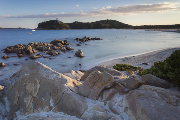 Sunset on the reef of Porto Giunco beach and the old tower, Villasimius, Cagliari, Sardinia, Italy, Europe.