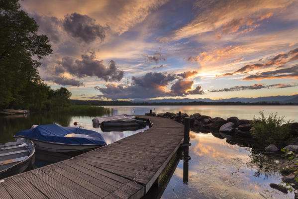 A summer sunset reflecting on Lake Varese at Cazzago Brabbia harbour, Varese Province, Lombardy, Italy.