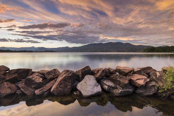 A summer sunset reflecting on Lake Varese at Cazzago Brabbia harbour, Varese Province, Lombardy, Italy.