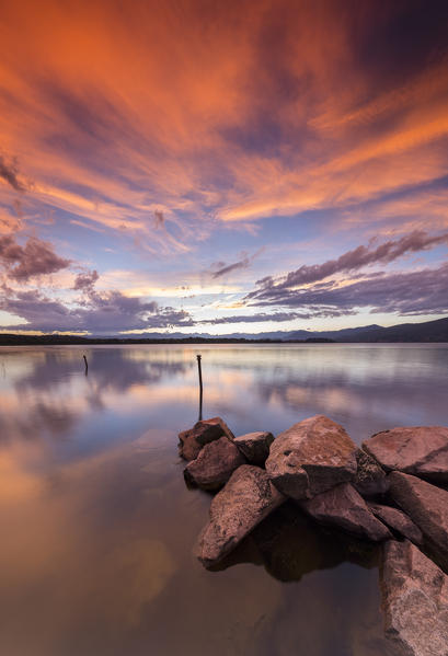 A summer sunset reflecting on Lake Varese at Cazzago Brabbia harbour, Varese Province, Lombardy, Italy.