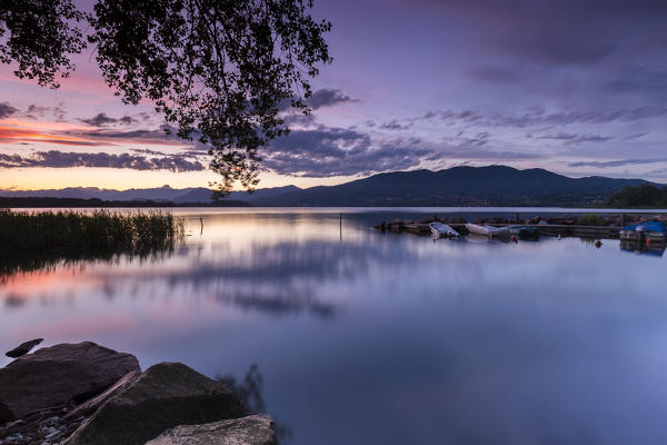 A summer sunset reflecting on Lake Varese at Cazzago Brabbia harbour, Varese Province, Lombardy, Italy.