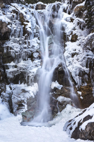 Vo' waterfall near Schilpario iced in winter. Val di Scalve, Bergamo province, Lombardy, Italy.