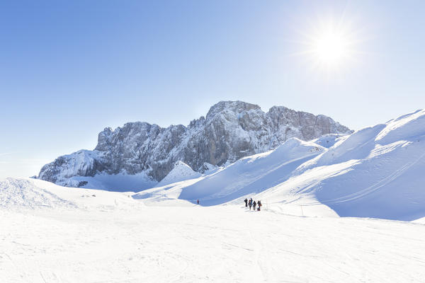 People snowshoeing on a trail to the north face of the Presolana, Val di Scalve, Bergamo district, Lombardy, Italy, Southern Europe.