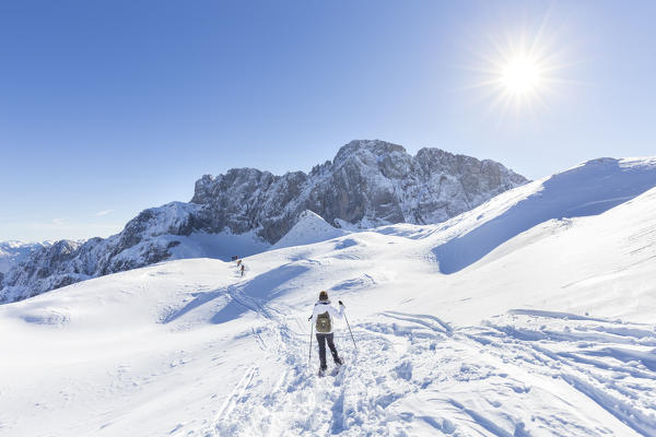 A girl snowshoeing at the foothills of the north face of the Presolana, Val di Scalve, Bergamo district, Lombardy, Italy, Southern Europe.