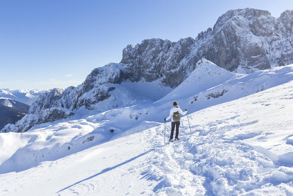 A girl snowshoeing at the foothills of the north face of the Presolana, Val di Scalve, Bergamo district, Lombardy, Italy, Southern Europe.