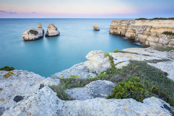 The Two Sisters stacks in front of the shore of Torre dell'Orso. Melendugno, province of Lecce, Salento, Apulia, Italy.