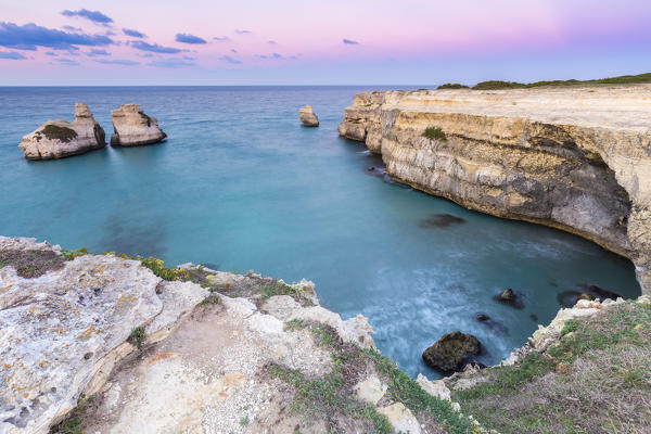 The Two Sisters stacks in front of the shore of Torre dell'Orso. Melendugno, province of Lecce, Salento, Apulia, Italy.