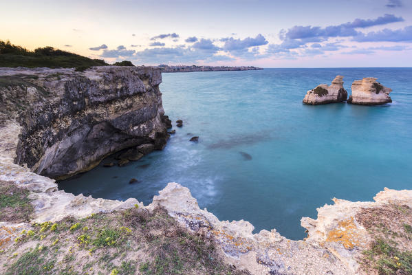The Two Sisters stacks in front of the shore of Torre dell'Orso. Melendugno, province of Lecce, Salento, Apulia, Italy.