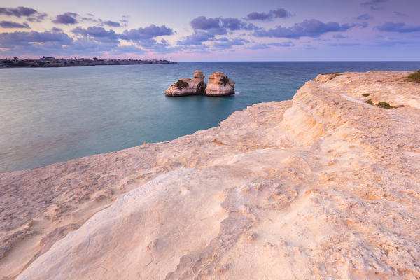 The Two Sisters stacks in front of the shore of Torre dell'Orso. Melendugno, province of Lecce, Salento, Apulia, Italy.