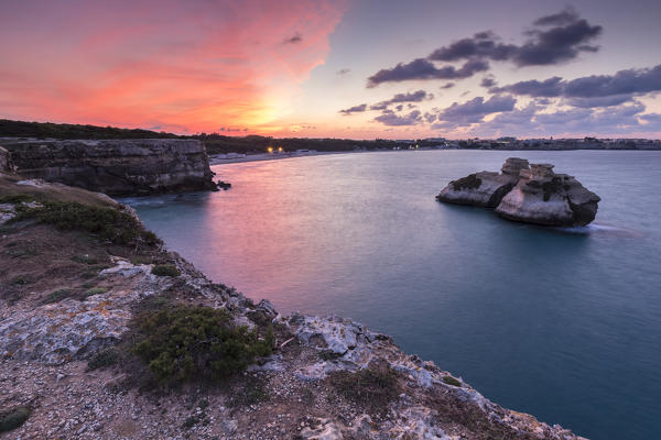 The Two Sisters stacks in front of the shore of Torre dell'Orso. Melendugno, province of Lecce, Salento, Apulia, Italy.