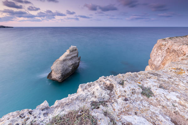 The Two Sisters stacks in front of the shore of Torre dell'Orso. Melendugno, province of Lecce, Salento, Apulia, Italy.