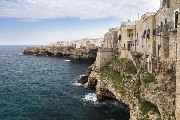 View of the overhanging houses and caves of Polignano a Mare. Bari district, Apulia, Italy, Europe.