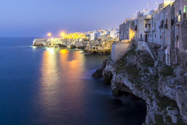 View of the overhanging houses and caves of Polignano a Mare at night. Bari district, Apulia, Italy, Europe.
