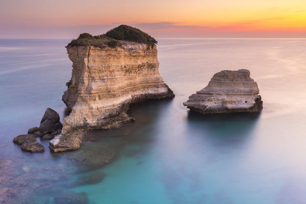 The Faraglioni of Torre Sant'Andrea at sunrise. Melendugno, province of Lecce, Salento, Apulia, Italy.