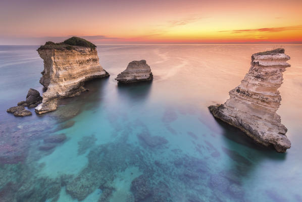 The Faraglioni of Torre Sant'Andrea at sunrise. Melendugno, province of Lecce, Salento, Apulia, Italy.