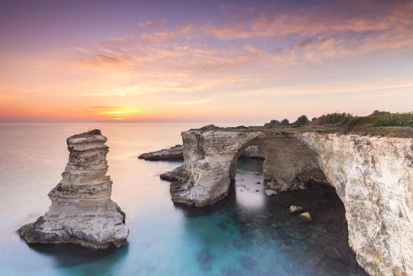 The Faraglioni of Torre Sant'Andrea at sunrise. Melendugno, province of Lecce, Salento, Apulia, Italy.