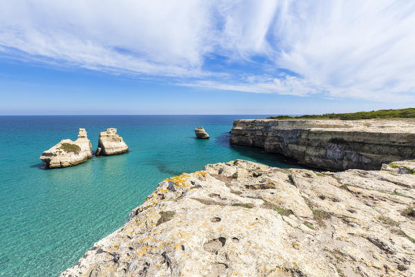 The Two Sisters stacks in front of the shore of Torre dell'Orso. Melendugno, province of Lecce, Salento, Apulia, Italy.