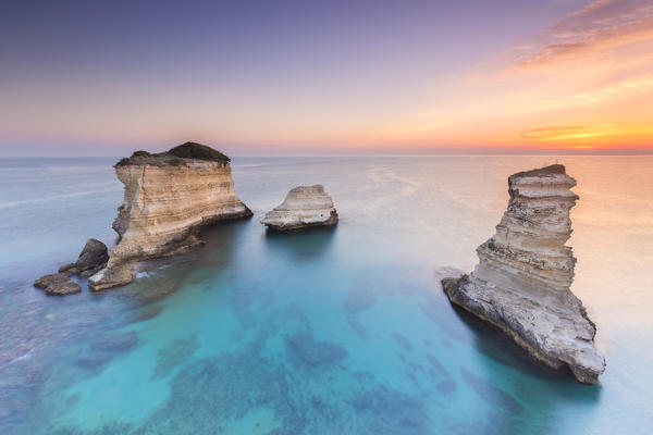 The Faraglioni of Torre Sant'Andrea at sunrise. Melendugno, province of Lecce, Salento, Apulia, Italy.